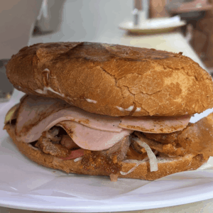 Authentic Mexican torta sandwich with meat, avocado and fresh ingredients in Dallas